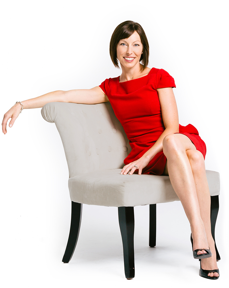 Katie Wagner sitting in a grey chair in a red dress