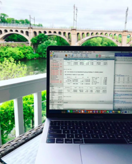 Run a 15-Minute SEO Audit | KWSM Development | MacBook Pro with open windows on a table outside overlooking a bridge